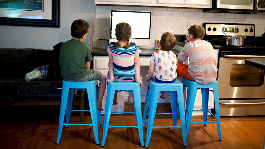 Kids learning around a computer