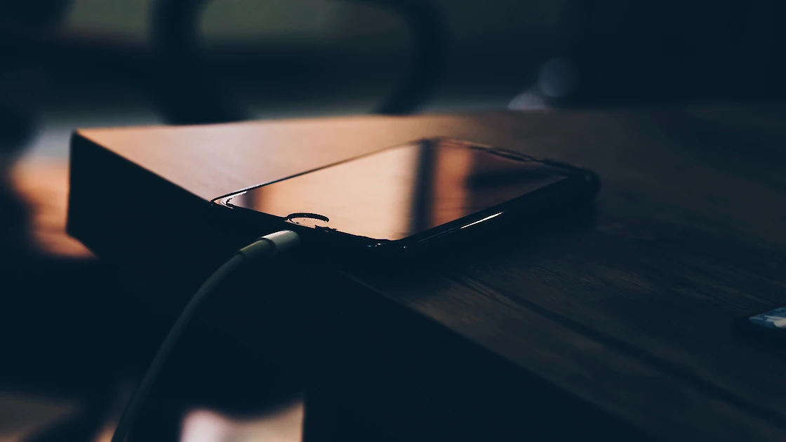 phone charging on a desk