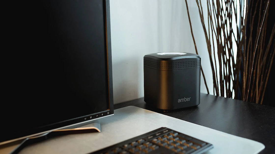 AmberPro on a desk with a computer and keyboard