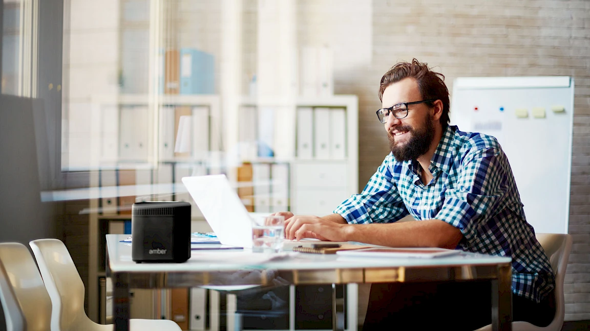 A man working with an AmberPRO cloud device nearby